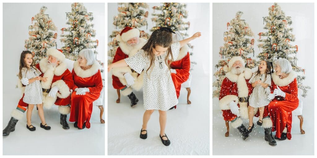 Young girl in a polka dot dress laughs, twirls, and sits with Santa and Mrs. Claus in front of snowy Christmas trees during Santa Minis with Haley Kinzie Photography.