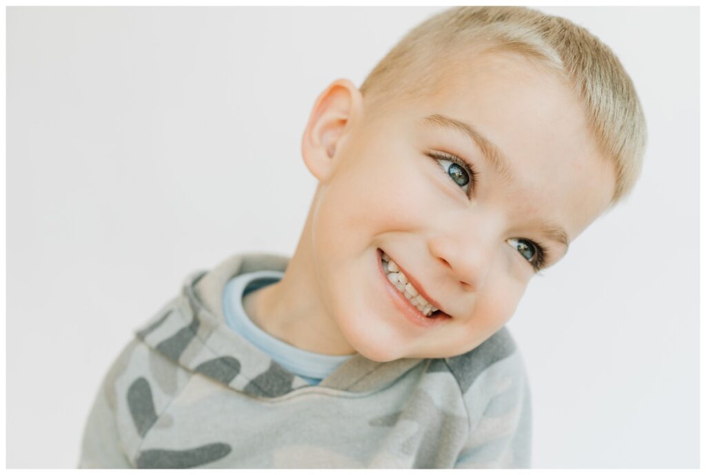 preschool boy smiling during school portraits 