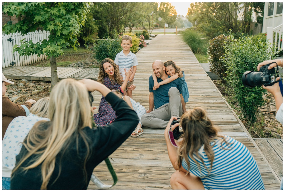 Photographers capturing a family on the boardwalk. Real families, golden light, and lots of laughter—each session brought the magic of storytelling to life.