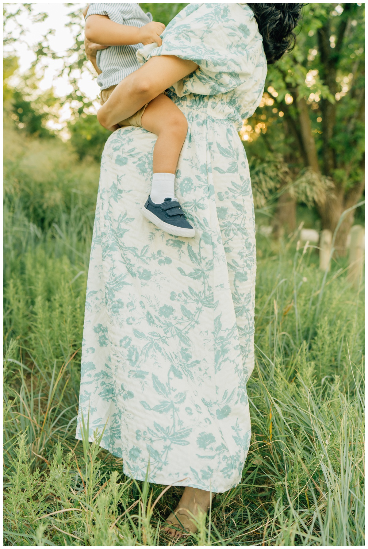 toddler sitting on baby bump in maternity session with Haley Kinize