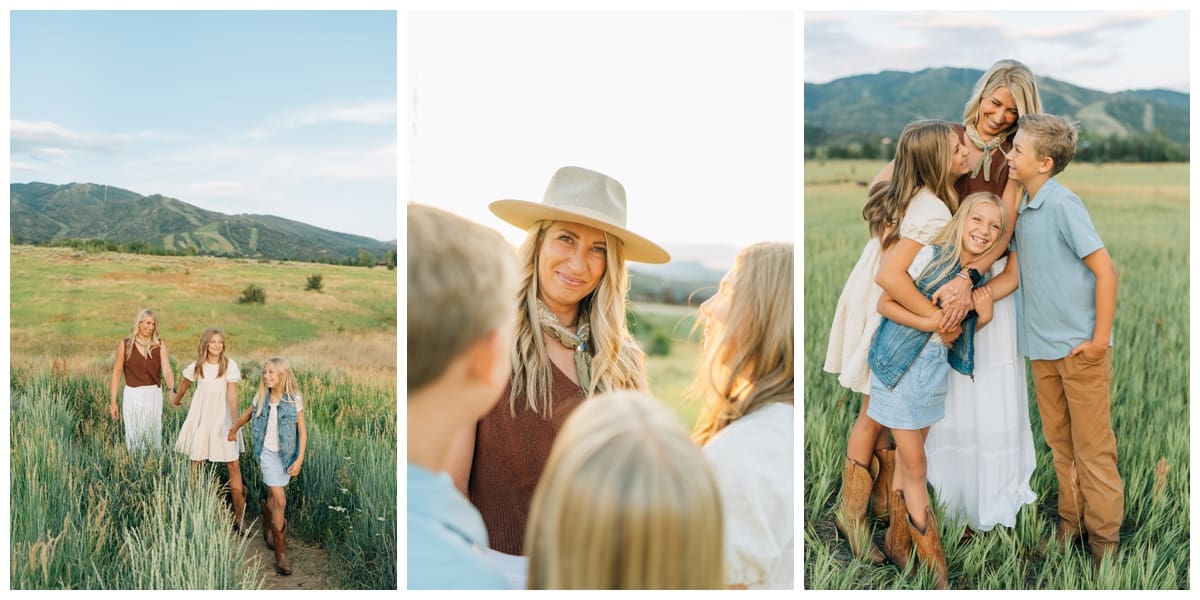 Mother walks with her two daughters in a mountain field, a candid family pose. Golden-hour of a mother in a wide-brimmed hat with her children. Mother hugs her three children in a joyful mountain field with Haley Kinzie Photography.