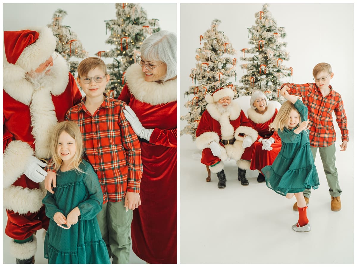 Kids in plaid and green outfits laugh and twirl in front of Santa and Mrs. Claus with snowy Christmas trees behind them.