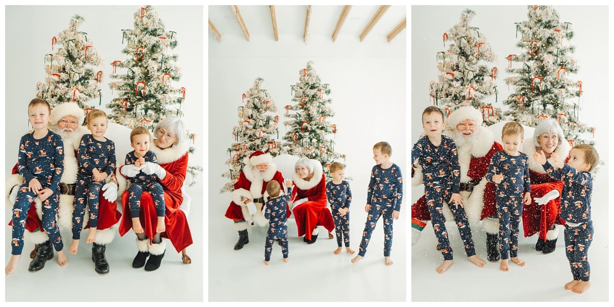 Three brothers in matching pajamas sit, laugh, and play in front of snowy Christmas trees.