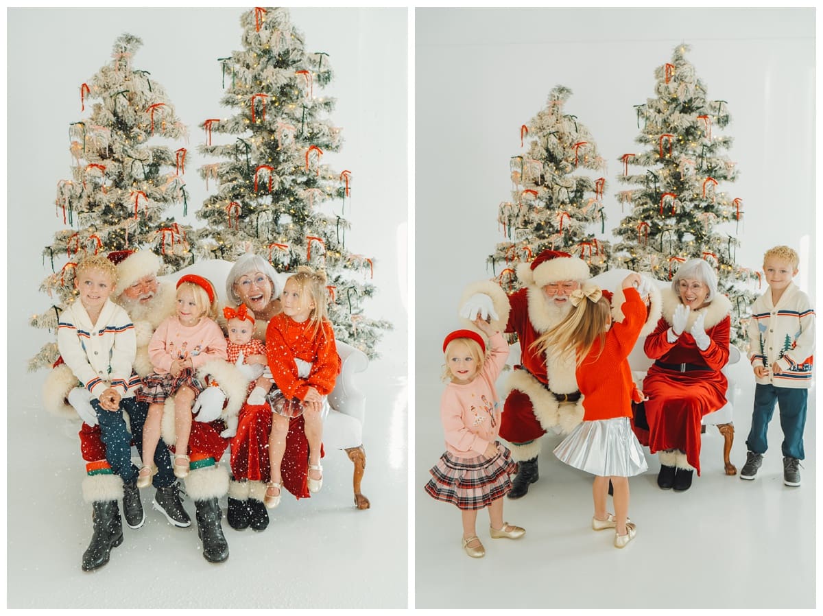 Four children in plaid and red outfits sit and dance joyfully with Santa and Mrs. Claus as snow falls during Santa Minis.
