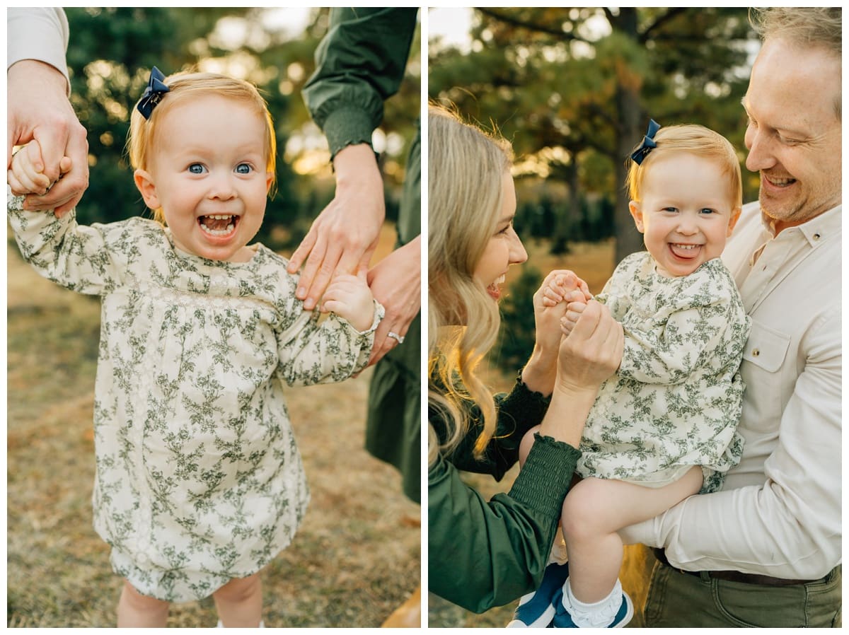 Toddler girl with red hair joyfully smiling at the camera with parents for family Christmas photos with green and ivory outfits
